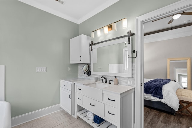 2909 Moss Bridge Ln, Myrtle Beach, SC 29579 - ensuite bathroom with backsplash, crown molding, wood finished floors, baseboards, and ceiling fan