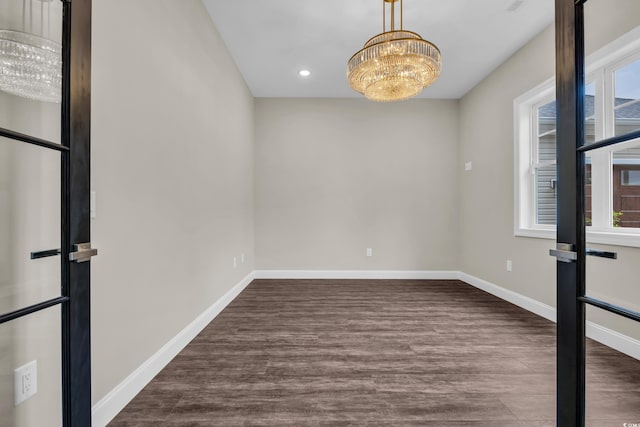 3995 Tillmond Dr, Conway, SC 29526 - empty room with healthy amount of natural light, recessed lighting, wood finished floors, baseboards, and a chandelier