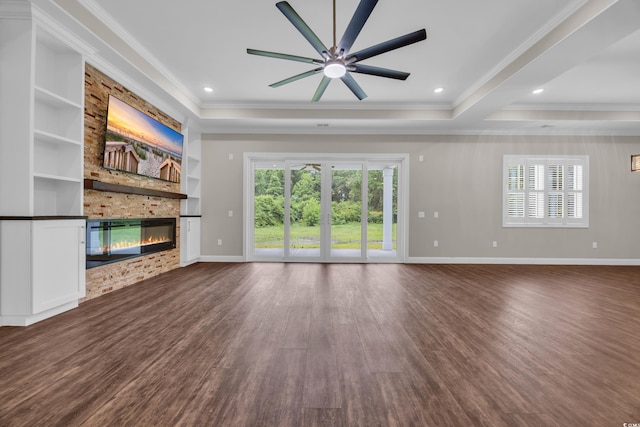 3995 Tillmond Dr, Conway, SC 29526 - unfurnished living room featuring healthy amount of natural light, a stone fireplace, a ceiling fan, ornamental molding, and dark wood finished floors