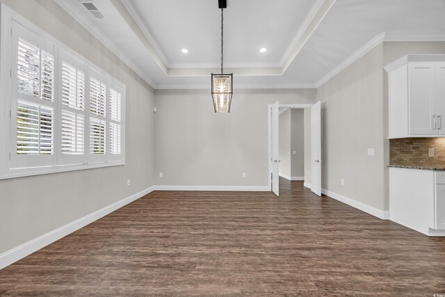 3995 Tillmond Dr, Conway, SC 29526 - unfurnished dining area with dark wood-style flooring, a chandelier, baseboards, crown molding, and a tray ceiling