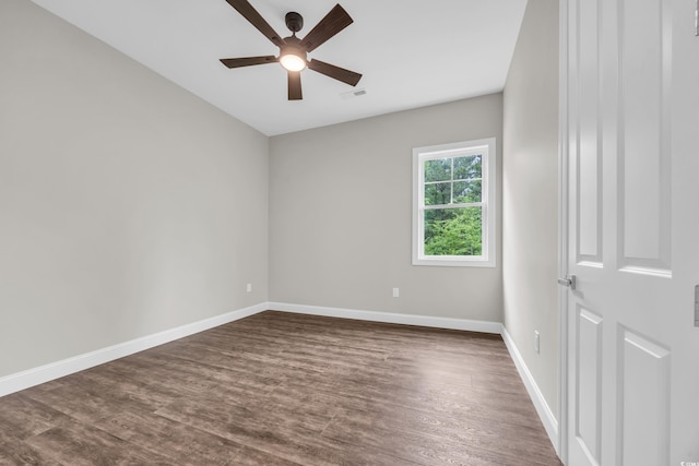unfurnished room with ceiling fan, dark wood-type flooring, and baseboards