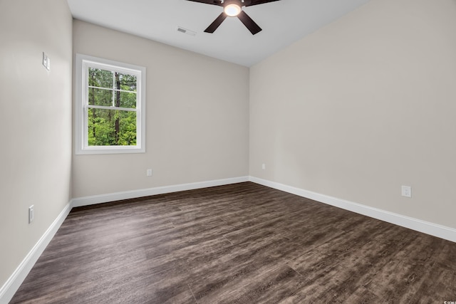 spare room with ceiling fan, baseboards, and dark wood finished floors