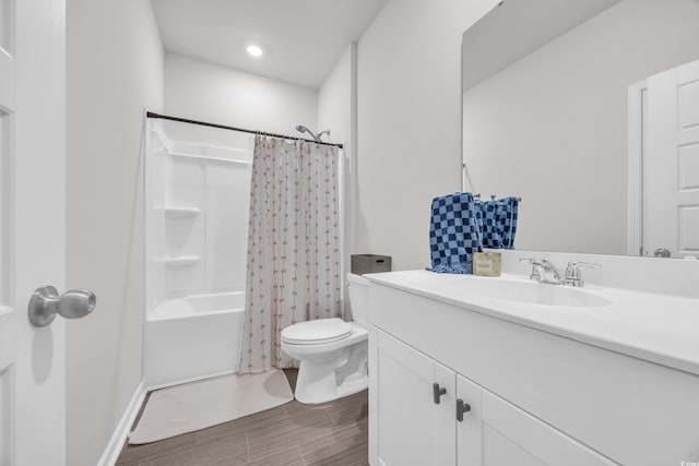 full bath featuring toilet, vanity, wood finished floors, and shower / bath combo