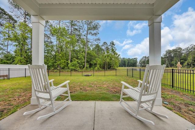 view of patio featuring view of wooded area