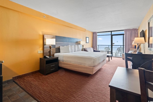 1501 S Ocean Blvd Unit 1231, Myrtle Beach, SC 29577 - carpeted bedroom with access to outside, floor to ceiling windows, baseboards, and stone finish floors