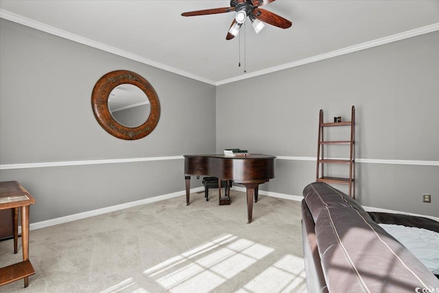 carpeted office space featuring a ceiling fan, crown molding, and baseboards