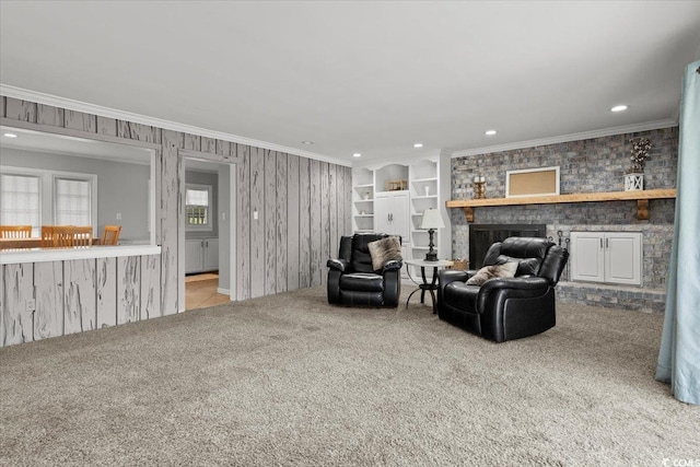 living room with carpet floors, ornamental molding, a fireplace, and recessed lighting