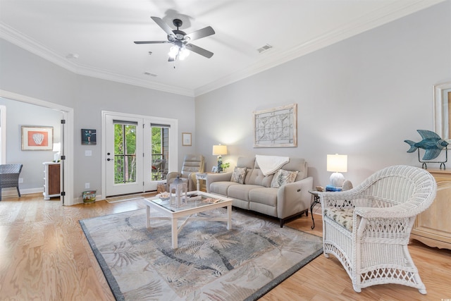 living room with ceiling fan, crown molding, light wood finished floors, and baseboards