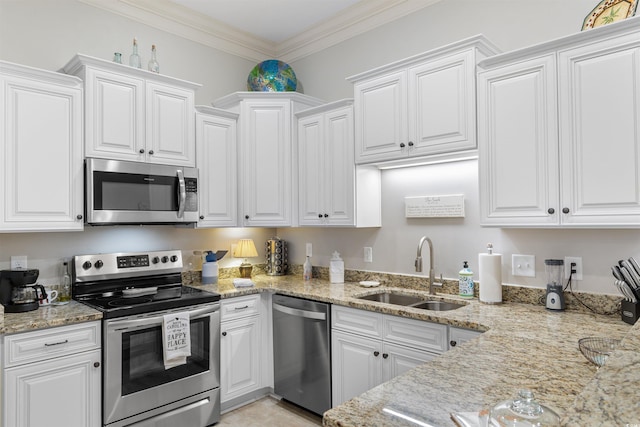 kitchen featuring stainless steel appliances, a sink, white cabinets, and ornamental molding