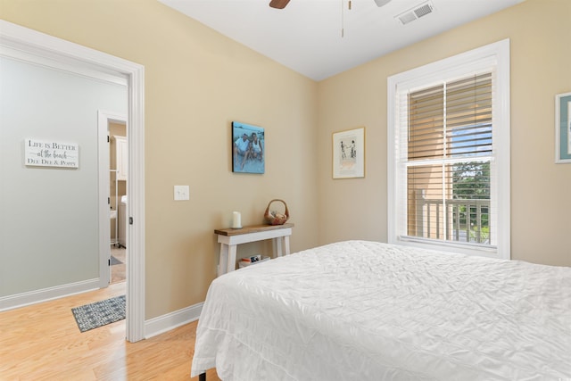 bedroom featuring light wood-style flooring, baseboards, and a ceiling fan