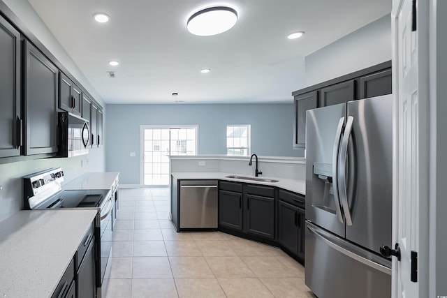 1031 Snowberry Dr, Longs, SC 29568 - kitchen with stainless steel appliances, a sink, a peninsula, light countertops, and recessed lighting