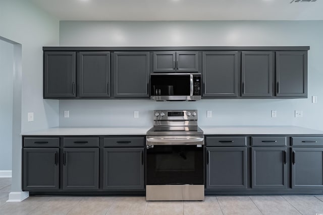 1031 Snowberry Dr, Longs, SC 29568 - kitchen with appliances with stainless steel finishes, light countertops, light tile patterned flooring, and gray cabinetry