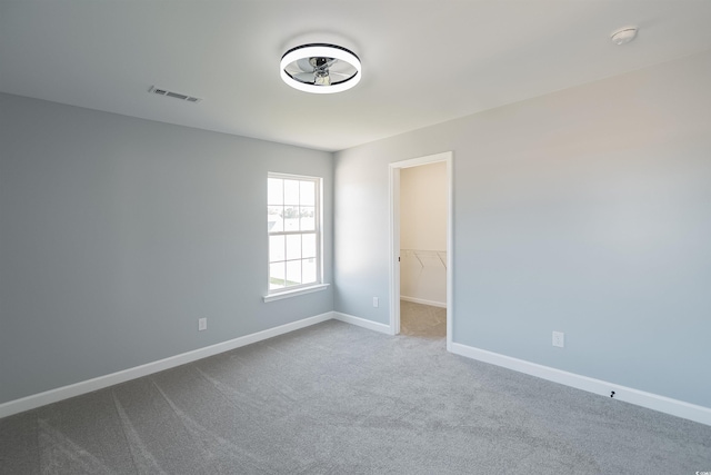 1031 Snowberry Dr, Longs, SC 29568 - unfurnished room with dark carpet, baseboards, a ceiling fan, and a smoke detector