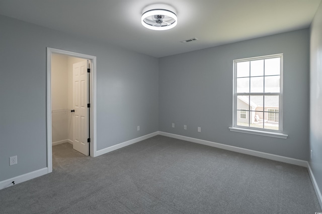 1031 Snowberry Dr, Longs, SC 29568 - unfurnished room featuring dark carpet, baseboards, and a ceiling fan