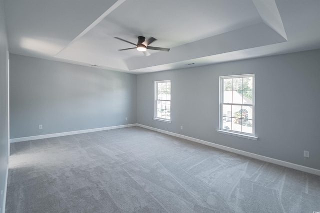1031 Snowberry Dr, Longs, SC 29568 - empty room featuring a tray ceiling, a ceiling fan, plenty of natural light, and baseboards