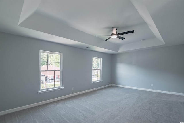 1031 Snowberry Dr, Longs, SC 29568 - empty room featuring a raised ceiling, a ceiling fan, plenty of natural light, and carpet flooring