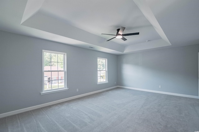 1031 Snowberry Dr, Longs, SC 29568 - carpeted empty room featuring a raised ceiling, plenty of natural light, baseboards, and a ceiling fan