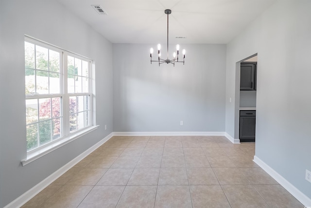 1031 Snowberry Dr, Longs, SC 29568 - empty room featuring a chandelier, healthy amount of natural light, light tile patterned floors, and baseboards