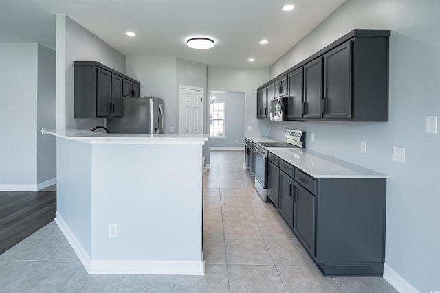 1031 Snowberry Dr, Longs, SC 29568 - kitchen featuring stainless steel appliances, a peninsula, light countertops, recessed lighting, and light tile patterned floors