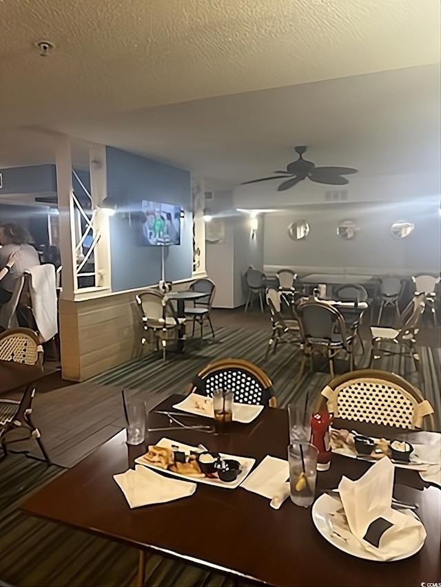 dining space featuring a ceiling fan and wood finished floors