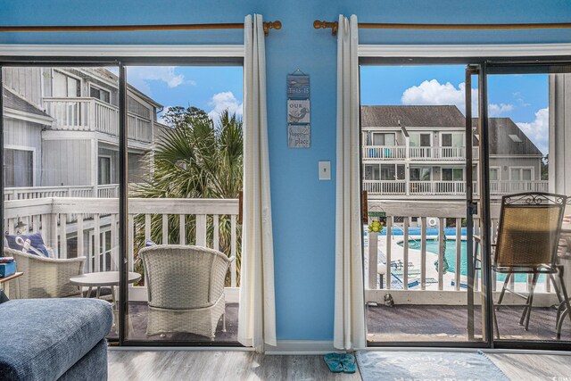 3700 Golf Colony Ln Unit 6J, Little River, SC 29566 - doorway featuring wood finished floors, plenty of natural light, and baseboards
