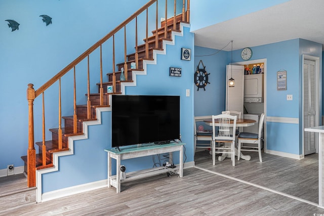 3700 Golf Colony Ln Unit 6J, Little River, SC 29566 - stairs featuring stacked washer / drying machine, wood finished floors, and baseboards
