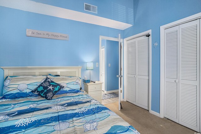 3700 Golf Colony Ln Unit 6J, Little River, SC 29566 - bedroom featuring carpet flooring, two closets, and baseboards