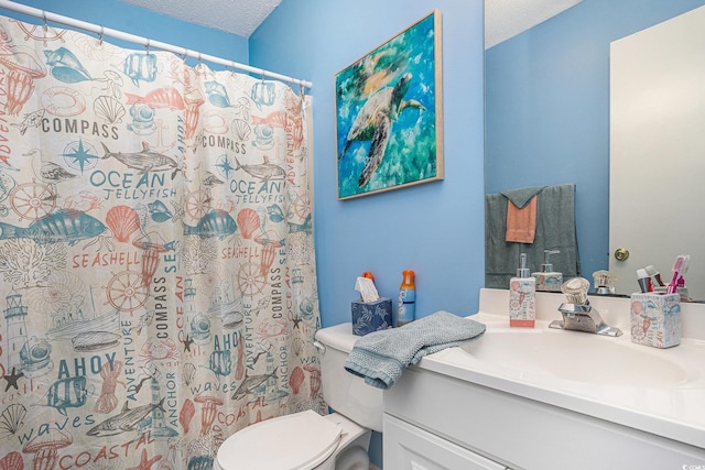 full bath featuring toilet, vanity, a textured ceiling, and curtained shower