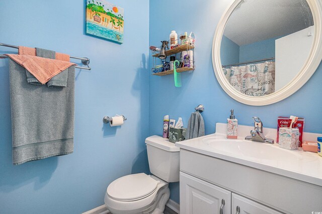 3700 Golf Colony Ln Unit 6J, Little River, SC 29566 - bathroom with toilet, vanity, and baseboards