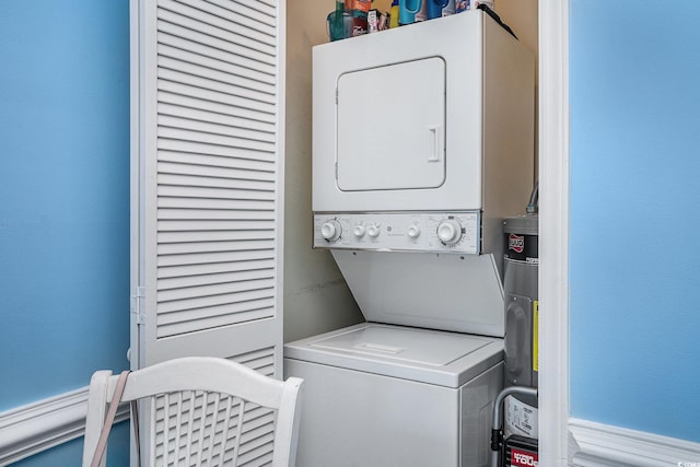 washroom featuring stacked washer and clothes dryer