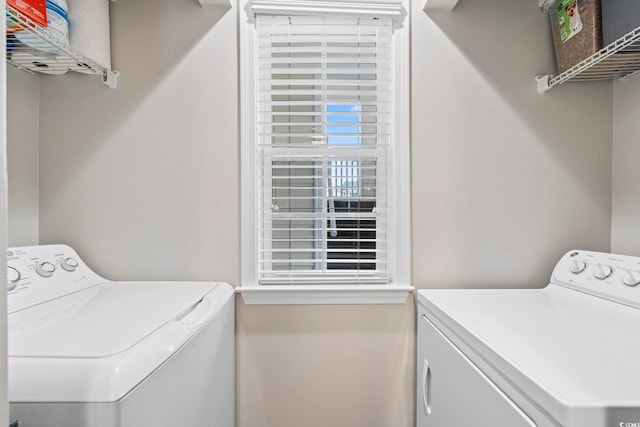 clothes washing area with independent washer and dryer