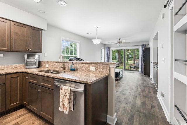 kitchen featuring dishwasher, a sink, wood finished floors, a peninsula, and dark brown cabinets