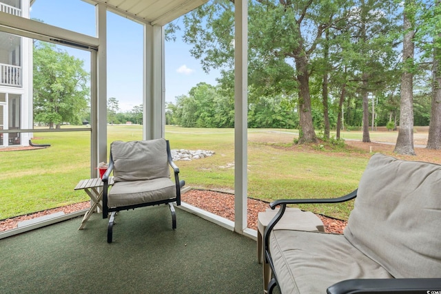 sunroom with view of wooded area