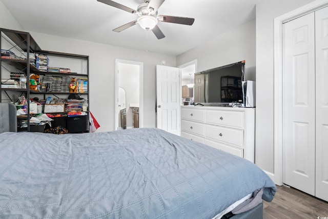 bedroom featuring wood finished floors, a ceiling fan, and ensuite bath