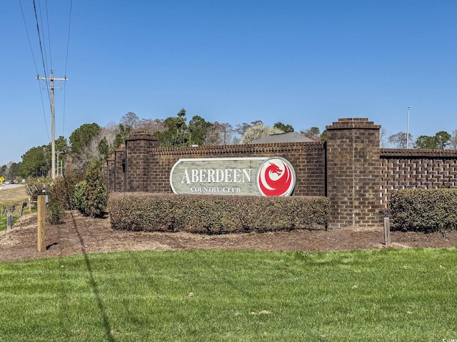 community / neighborhood sign with a lawn
