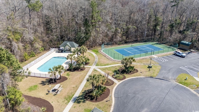 drone / aerial view of a pool and a forest