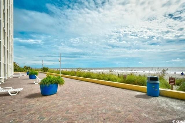 surrounding community featuring view of water and beach
