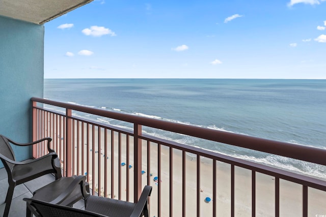 balcony featuring view of water and beach