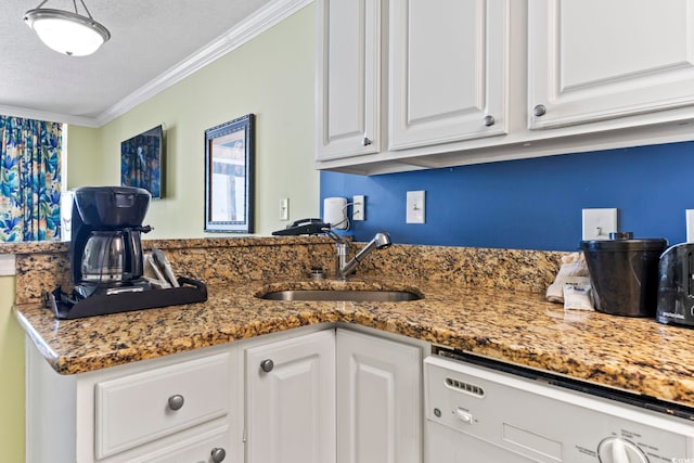 kitchen with dishwasher, a sink, a textured ceiling, white cabinetry, and crown molding