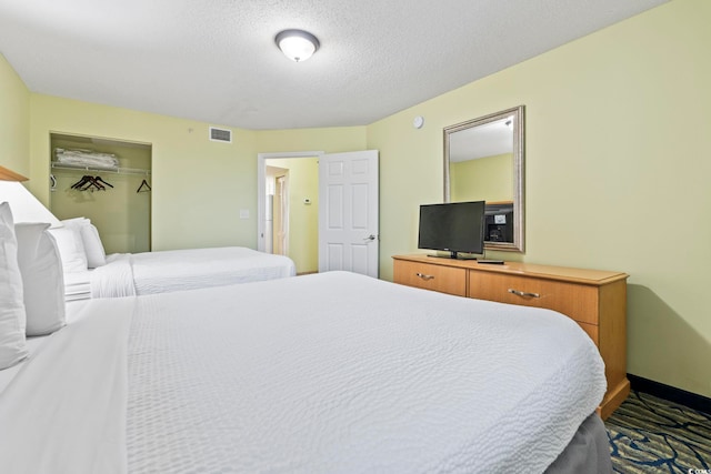 bedroom featuring baseboards and a textured ceiling