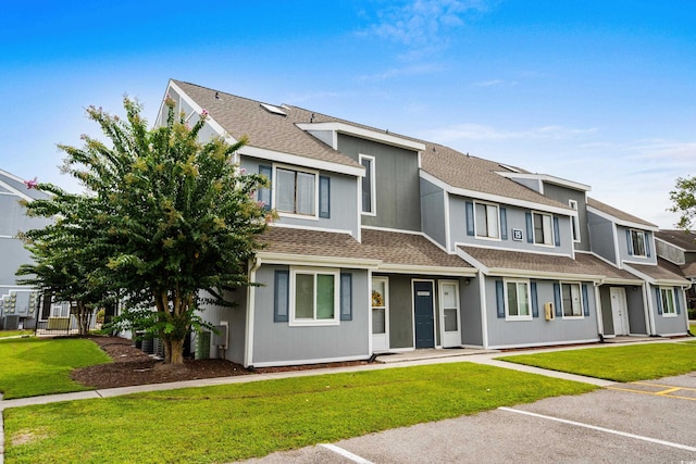 1891 Colony Dr Unit 15J, Surfside Beach, SC 29575 - townhome / multi-family property with roof with shingles, uncovered parking, and a front lawn
