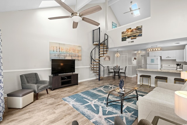1891 Colony Dr Unit 15J, Surfside Beach, SC 29575 - living room with high vaulted ceiling, stairway, light wood finished floors, a ceiling fan, and baseboards