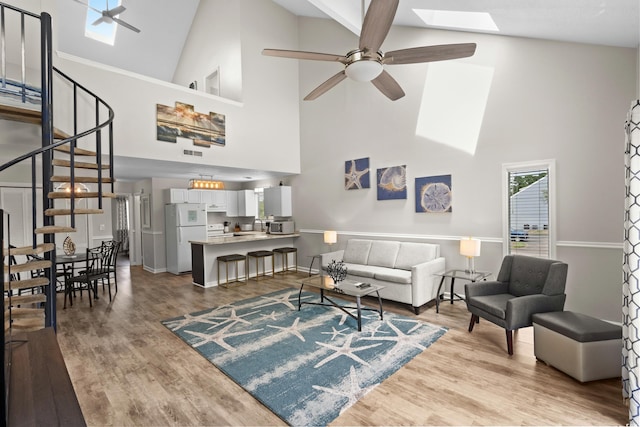 1891 Colony Dr Unit 15J, Surfside Beach, SC 29575 - living area featuring a skylight, high vaulted ceiling, ceiling fan, stairs, and wood finished floors