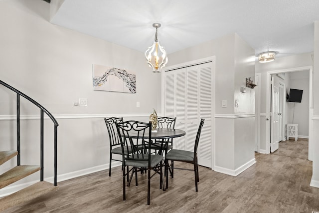 1891 Colony Dr Unit 15J, Surfside Beach, SC 29575 - dining space with stairs, wood finished floors, a chandelier, and baseboards