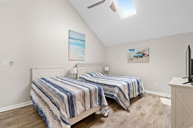 1891 Colony Dr Unit 15J, Surfside Beach, SC 29575 - bedroom with wood finished floors, a skylight, lofted ceiling, baseboards, and a ceiling fan