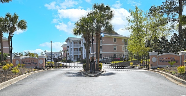 637 Waterway Village Blvd Unit 13C, Myrtle Beach, SC 29579 - view of asphalt street with a gate, street lights, curbs, and a gated entry