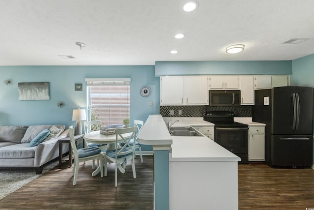 637 Waterway Village Blvd Unit 13C, Myrtle Beach, SC 29579 - kitchen with black range with electric cooktop, freestanding refrigerator, a sink, light countertops, and dark wood finished floors