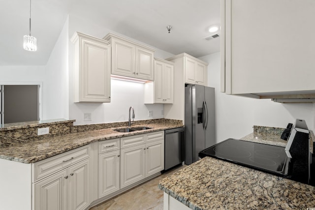 144 Puffin Dr Unit 2A, Pawleys Island, SC 29585 - kitchen featuring dishwashing machine, range with electric stovetop, stainless steel refrigerator with ice dispenser, a sink, and light stone countertops
