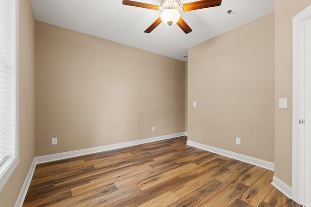144 Puffin Dr Unit 2A, Pawleys Island, SC 29585 - empty room with dark wood-style flooring, a ceiling fan, baseboards, and a pendent fire sprinkler
