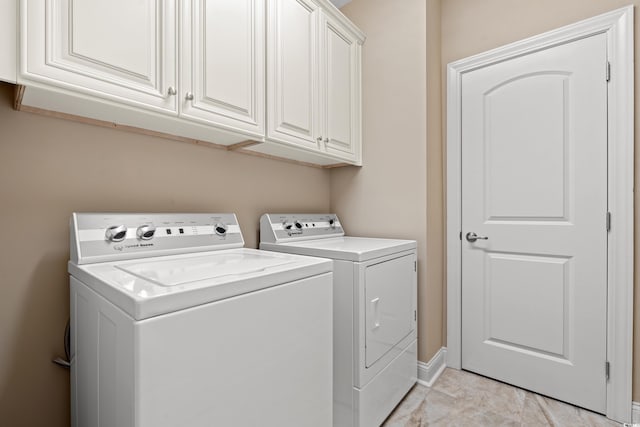 144 Puffin Dr Unit 2A, Pawleys Island, SC 29585 - laundry area with washer and dryer, cabinet space, and baseboards